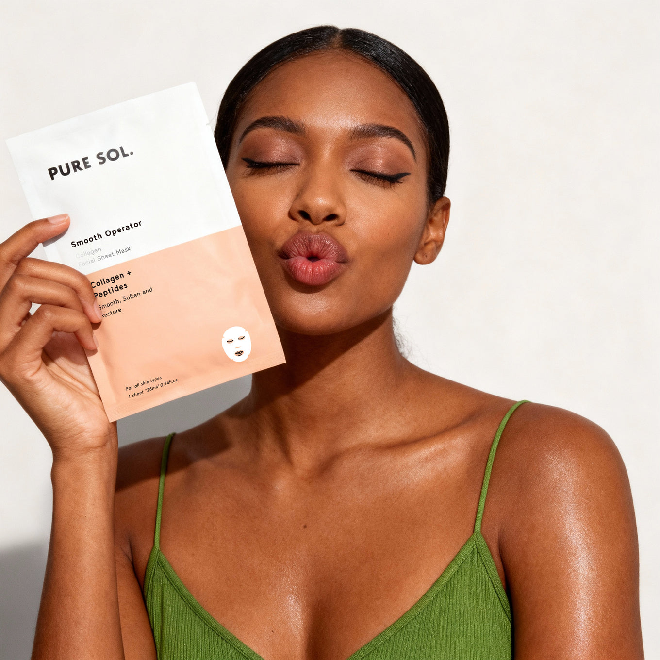Woman holding a Pure Sol skincare product against a white background